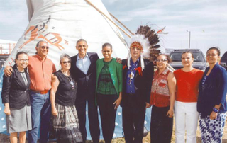 Jodi Gillette, far left, stands with President Obama, first lady Michelle Obama, and members of Gillette's family including, her parents, Dave Archambault I and Betty Archambault; brother Dave Archambault II, chairman of the Standing Rock Sioux Tribe; sisters Billi Hornbeck and Sunshine Archambault Carlow; and sister-in-law Nicole Thunder Hawk Archambault, during the president's historic trip to Standing Rock Sioux Reservation in June 2014.